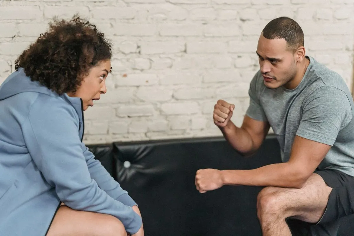 A personal trainer showing a client an exercise