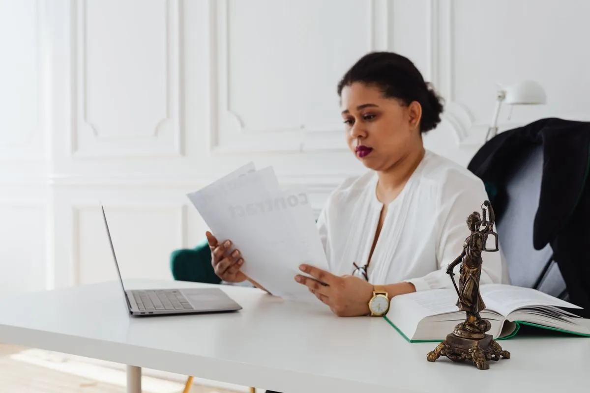 A lawyer reading documents at her desk